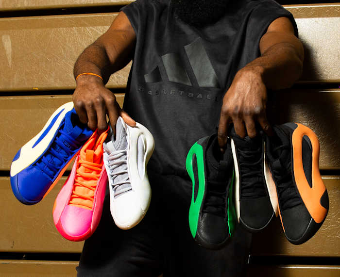 James Harden holds six pairs of his multicolor adidas basketball shoes.